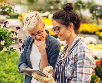 Two gardeners using a tablet to download a COI