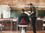 Professional barber cutting client's hair